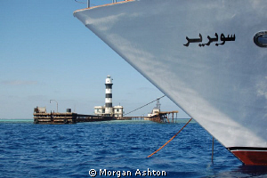 Daedalus Reef Lighthouse and the bow of the Emperor Super... by Morgan Ashton 